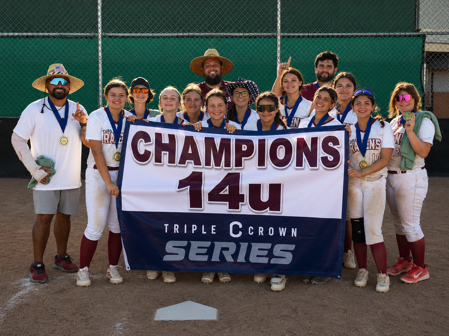 Yuba Ravens 14U team holding a championship banner
